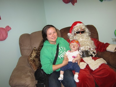A close up of a Mother and her baby with Santa